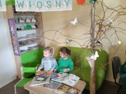 Dwie dziewczynki przeglądają książeczki z wierszami