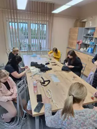 Uczestniczki zajęć wykonują torebkę ze sznurka.