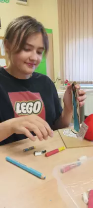 Uczestniczka maluje anioła dla mamy.