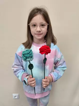 Uczestniczka zajęć ze swoją szydełkową pracą.