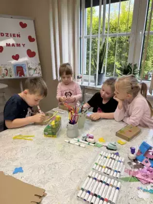 Uczestnicy ozdabiają pudełeczka dla mam.