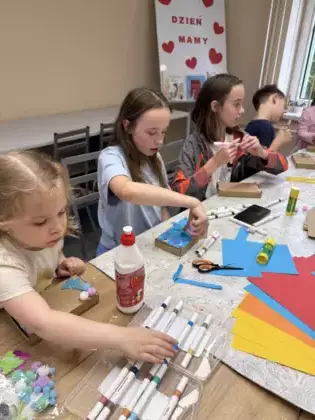 Uczestnicy ozdabiają pudełeczka dla mam.