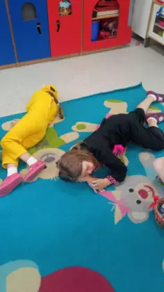 Zabawy przedszkolaków na dywanie.