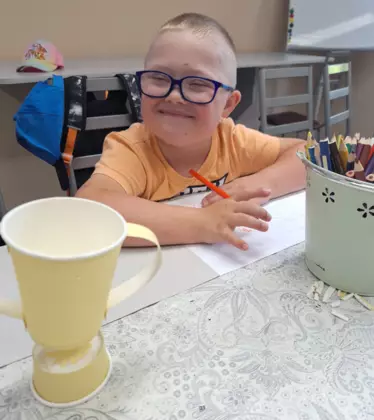 Chłopczyk maluje obrazek dla taty.