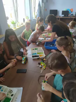 Uczestnicy składają z klocków lego pojazdy.