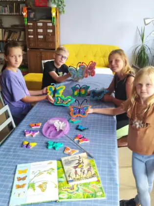 Dzieciaki pokazują motylki, które same zrobiły.