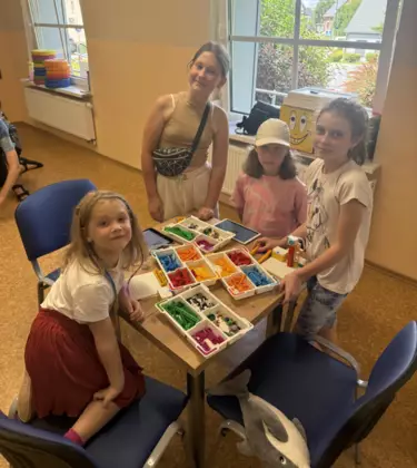 Dziewczyny budują z klocków lego.