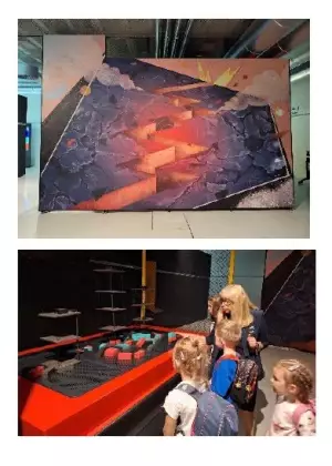 Malowidło z popękaną skorupą Ziemi i makieta budynków po trzęsieniu Ziemi, którą oglądają dzieci.