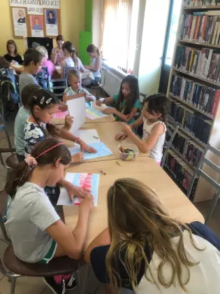 Dzieci kolorują szalik dla Szymborskiej.