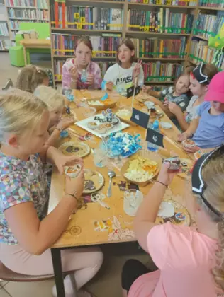 Dzieci lukrują babeczki.