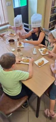 Dzieci dekorują słodkie ciasteczka.